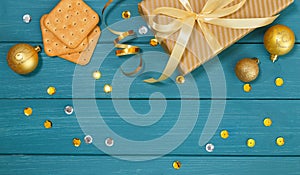 Christmas or new year composition, wooden blue background and golden christmas decorations