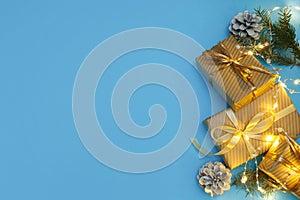 Christmas or new year composition, wooden blue background and golden christmas decorations