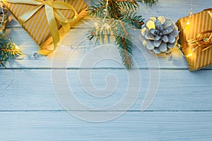 Christmas or new year composition, wooden blue background and golden christmas decorations