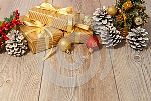 Christmas or new year composition, wooden pink background and golden christmas decorations