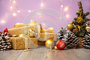 Christmas or new year composition, wooden pink background and golden christmas decorations