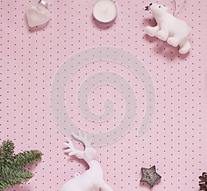 Christmas or New Year concept frame with festive decoration on the pink polka dot background. Winter holiday flat lay.