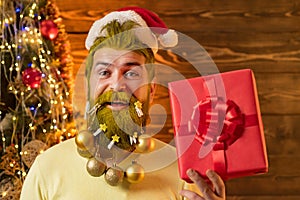 Christmas or New Year concept. Hipster modern Santa Claus wishes Merry Christmas. Styling Santa Claus with a long beard