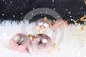 Christmas and New Year on a dark background, for branches with decorations in snow flakes, place for text. New Year card for