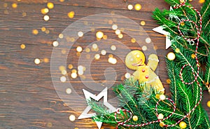 Christmas or New Year decor. Gingerbread on the texture of fir branches on wooden background