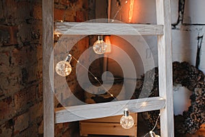 Christmas and New Year decorated interior room with light bokeh garland. Loft trend interior