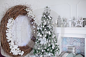 Christmas and New Year decorated white interior room with presents and New year tree and fireplace