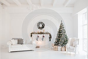 Christmas and New Year decorated white interior room with presents and New year tree and fireplace