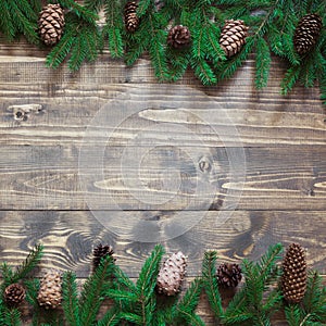 Christmas decoration background. Fir tree branches on wooden background with copy space. Top view and flat lay.
