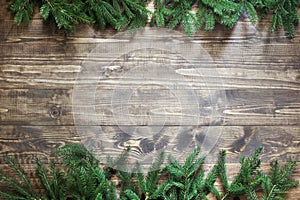 Christmas decoration background. Fir tree branches on wooden background with copy space. Top view and flat lay. Pattern.