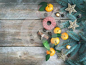 Christmas (New Year) decoration background set: fur-tree branches, glass balls, golden glittering toy stars, cinnamon