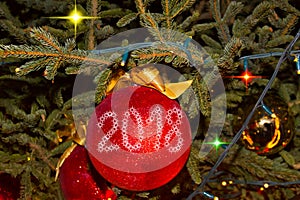 Christmas and New Year Decoration. Baubles hanging on Christmas Tree.