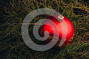 Christmas New Year decoration composition. Top view of fur-tree branches and balls frame on wooden background with place for your