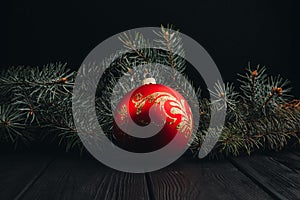 Christmas New Year decoration composition. Top view of fur-tree branches and balls frame on wooden background with place for your