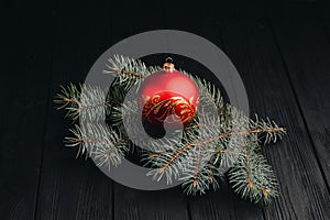 Christmas New Year decoration composition. Top view of fur-tree branches and balls frame on wooden background with place for your