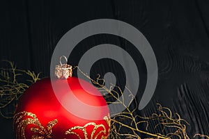 Christmas New Year decoration composition. Top view of fur-tree branches and balls frame on wooden background with place for your