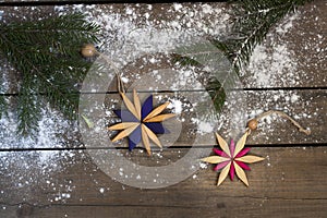 Christmas New Year decoration composition. Top view of fur-tree branches and star frame on wooden background