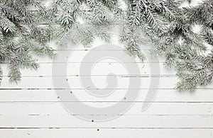 Christmas and New Year decoration composition. Top view of fur-tree branches on wooden background with place for your