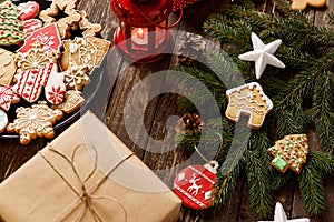 Christmas, New Year decoration cookies and biscuits on wooden background with conifer evergreen branches