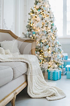 Christmas or new year decoration at Living room interior and holiday home decor concept. Calm image of blanket on a vintage sofa