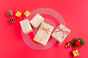 Christmas and New year decorations, Gift box, Pine cones, Pine branch, Golden bell and Red decoration christmas ball on red backgr