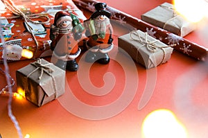 Christmas and New Year decorations mock up or flat lay on red background. Gifts, garland, snowman. Winter, New Years holidays conc