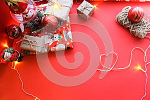 Christmas and New Year decorations mock up or flat lay on red background. Gifts, garland, snowman. Winter, New Years holidays conc