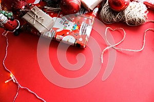 Christmas and New Year decorations mock up or flat lay on red background. Gifts, garland, snowman. Winter, New Years holidays conc