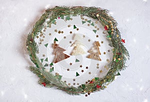 Christmas or New year festive background. Greeting card composition with green wreath, glitters and fir trees made of bread. Holid