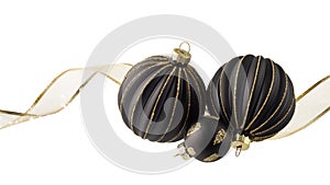 Christmas or new year festive decoration, black glass balls with golden glitters and ribbon isolated on white background