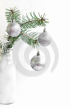 Christmas, New year, fir-tree branch, branch ate on a white background, a fir-tree branch with toys, silvery toys,