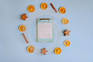 Christmas, New Year flat lay on blue background. Christmas decorations with dry spices, orange rings, cinnamon. Coffee Cup