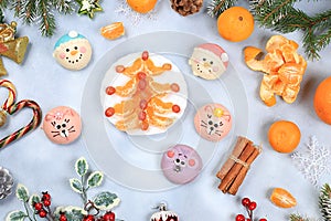 Christmas new year food, traditional festive tangerine and grape salad with sweets, fir branches and cones and decorations on a