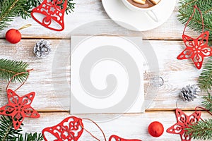 Christmas or New Year frame composition. Decorations, red stars, bells, cones, fir and spruce branches, on a white wooden