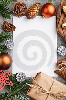 Christmas or New Year frame composition, template. Decorations, cones, fir and spruce branches, cup of coffee, on a gray concrete