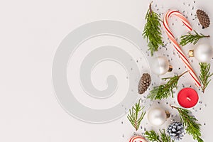 Christmas and New Year frame for your lettering in the style of minimalism. Small green pine branches, cones, Christmas balls,
