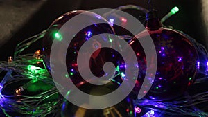 Christmas, New year, garland and Christmas balls, dark background, flashing different colors of lights