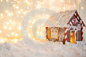 Christmas and New Year greeting card. Christmas concept. gingerbread house on the background of garlands
