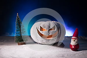 Christmas New Year or Halloween Celebrate Background with Little Christmas Tree on Blurred Bokeh Snow Background with horror