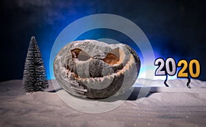 Christmas New Year or Halloween Celebrate Background with Little Christmas Tree on Blurred Bokeh Snow Background with horror