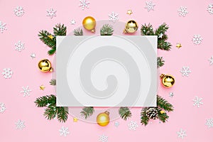 Christmas, New Year holiday card with copy space for text. Blank white paper in frame of natural fir tree branches, gold