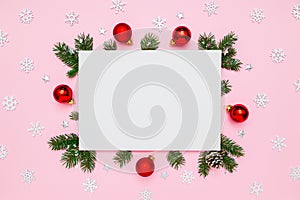 Christmas, New Year holiday card with copy space for text. Blank white paper in frame of natural fir tree branches, red
