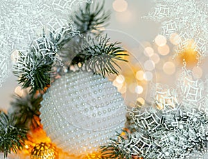 Christmas and New Year Holiday greeting card. Beautiful ball, pine branches and a garland in the snow.