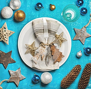 Christmas, New Year holiday table setting over bright blue background