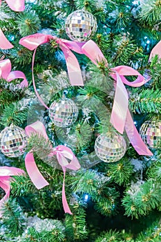 Christmas and New Year holidays background. Christmas tree decorated with silver disko balls, bows and garlands. Glittering and