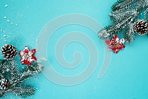 Christmas and New Year holidays background with snow fir tree and pine cones on blue background , winter season