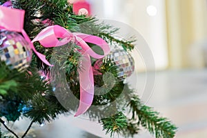 Christmas and New Year holidays background. Christmas tree decorated with silver disko balls, bows and garlands. Glittering and