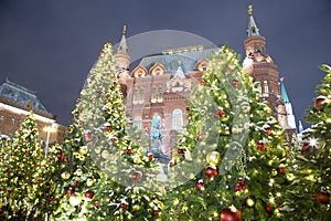 Christmas New Year holidays illumination and State Historical Museum inscription in Russian at night, Moscow