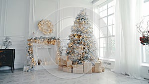 Christmas and New Year interior in light classic style. White room with Xmas Tree decorated, flashing garland, balls, fireplace