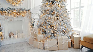 Christmas and New Year interior in light classic style. White room with Xmas Tree decorated, flashing garland, balls, fireplace